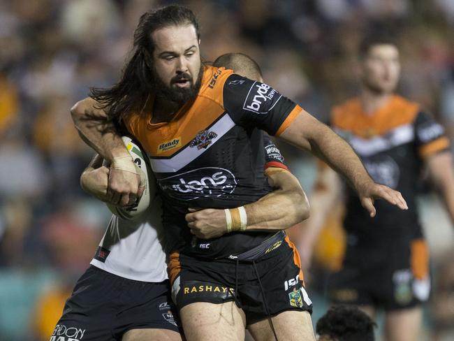 Wests Tigers prop Aaron Woods tests the Warriors defence in his last game for the club.