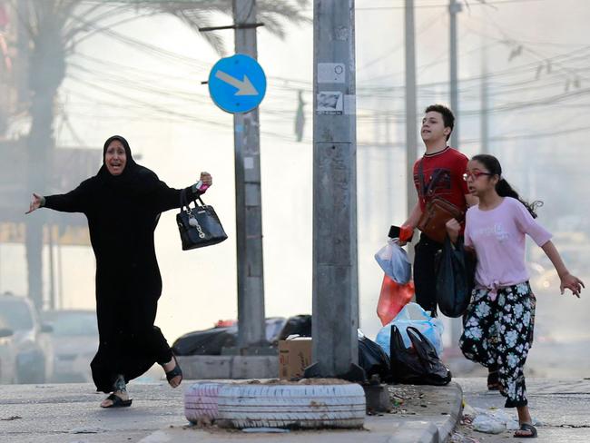 Palestinians run for cover after a strike near the Al-Shifa hospital in Gaza City on November 1. Picture: Bashar Taleb/AFP