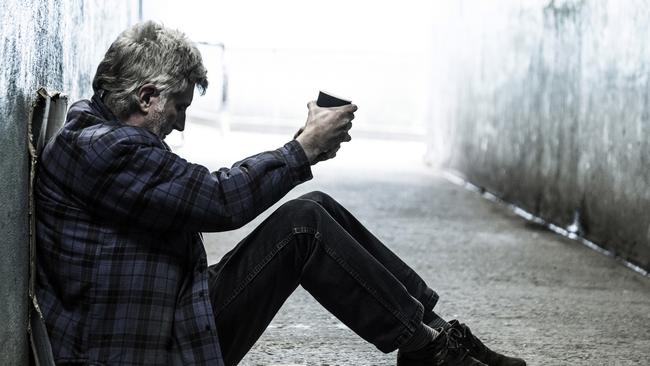 Homeless senior man sitting and begging alone in a subway tunnel. Picture: iStock