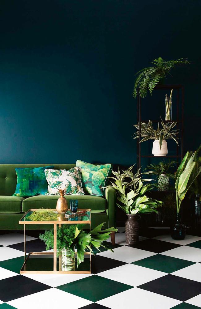 Experiment with multiple emerald tones and mismatched cushions.