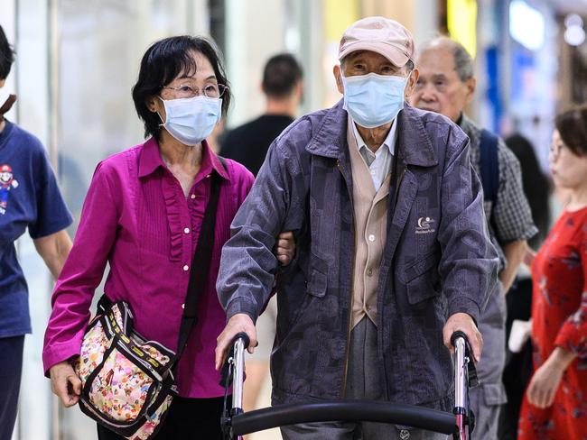 An elderly couple wearing protective face masks amid the COVID-19 pandemic. Picture: James Gourley