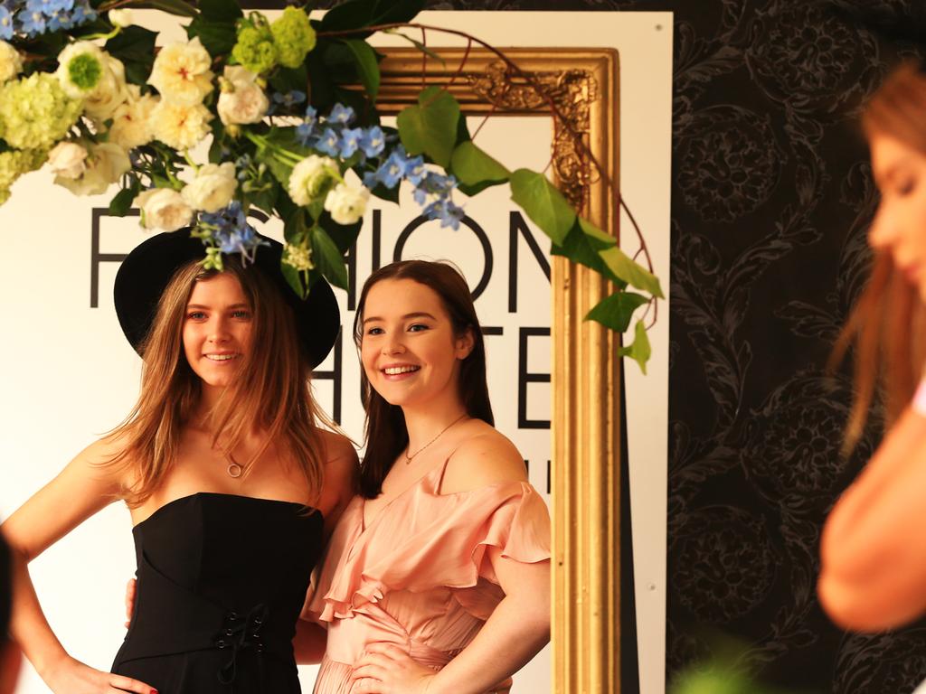 Trinity and Brianna Tuckerman get their portrait done during The TAB Everest Day at Randwick Racecourse in Sydney. Pic Jenny Evans