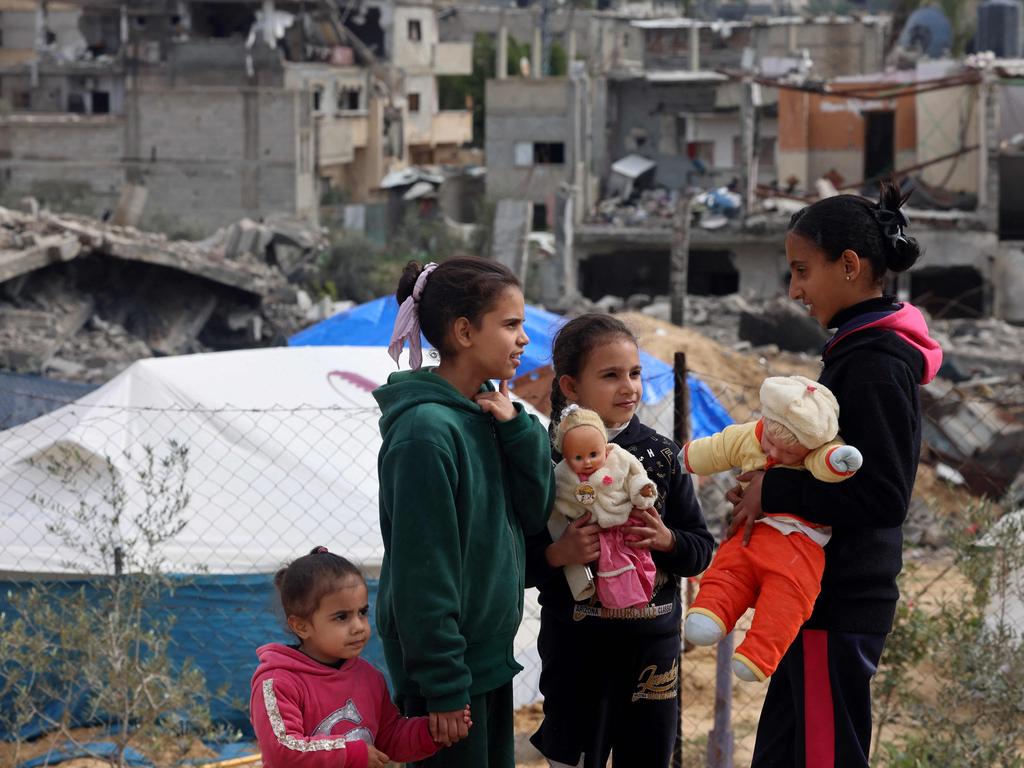 Palestinian children play in front of rubble at a makeshift camp housing displaced Palestinians in Rafah in the southern Gaza Strip. Picture: AFP