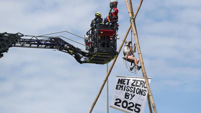 Emergecy crews work to get an Extinction Rebellion protestor off a tripod which was blocking traffic on the Hale Street exit on the Riverside Expressway. Pic Peter Wallis