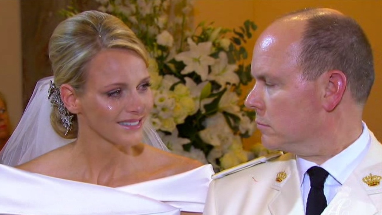 Prince Albert speaks to his new bride, Charlene Princess of Monaco, with a tear on her cheek during their wedding service in 2011. Picture: AP