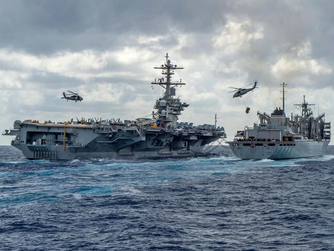 TOPSHOT - This handout picture released by the US Navy on May 8, 2019 shows the Nimitz-class aircraft carrier USS Abraham Lincoln (CVN 72) while conducting a replenishment-at-sea with the fast combat support ship USNS Arctic (T-AOE 9), while MH-60S Sea Hawk helicopters assigned to the "Nightdippers" of Helicopter Maritime Strike Squadron (HSM) 5, transfer stores between the ships. - The US is deploying an amphibious assault ship and a Patriot missile battery to bolster an aircraft carrier and B-52 bombers already sent to the Gulf, ratcheting up pressure on Iran. The USS Arlington, which transports marines, amphibious vehicles, conventional landing craft and rotary aircraft, and the Patriot air defence system will join the Abraham Lincoln carrier group, the Pentagon announced on May 10. (Photo by MCSN Jason Waite / Navy Office of Information / AFP) / RESTRICTED TO EDITORIAL USE - MANDATORY CREDIT "AFP PHOTO /US NAVY" - NO MARKETING NO ADVERTISING CAMPAIGNS - DISTRIBUTED AS A SERVICE TO CLIENTS