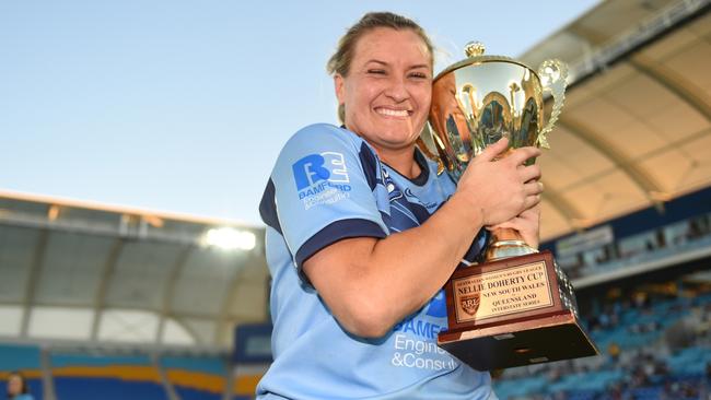NSW captain Ruan Sims clutches the Nellie Doherty Cup after the Blues win the women’s Origin. Pic: Scott Davis