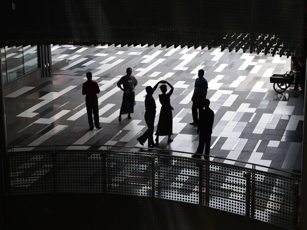 People practice ballroom dancing in a shopping mall in Beijing on June 17, 2015. Picture: AFP