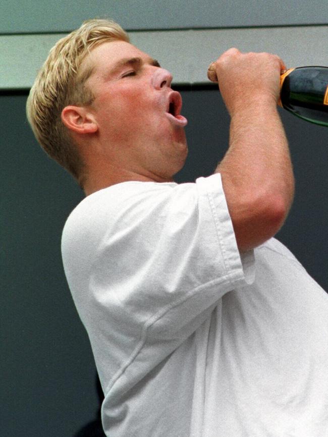 Warne swigging champagne after an Ashes win over England.