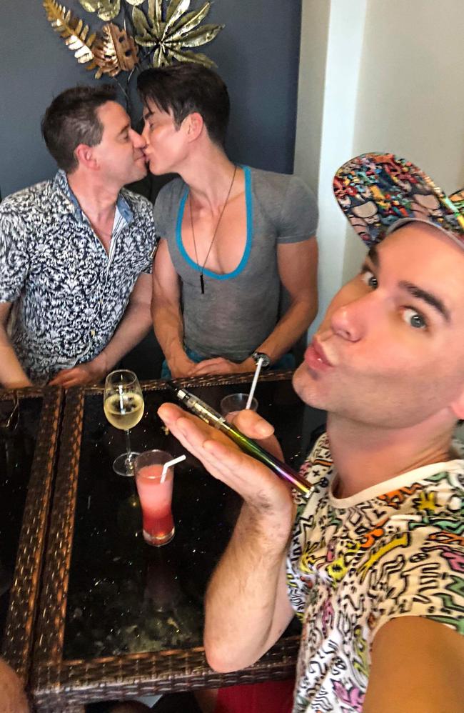 Stephen Walden poses while Justin Jedlica kisses Jayson McNaughton.