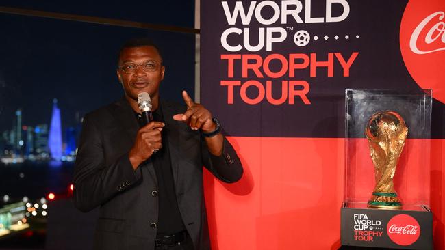 Former French football player Marcel Desailly speaks beside the Qatar 2022 World Cup trophy as it is displayed during its arrival back in the country. Picture: AFP