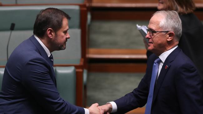 Labor MP Ed Husic, and Parliament’s first Muslim MP, shakes hands with Prime Minister Malcolm Turnbull in the House of Representatives Chamber at Parliament House in Canberra. (Pic: Kym Smith)