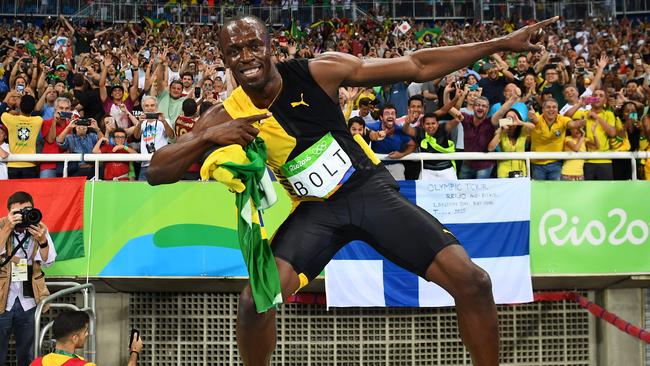 Usain Bolt celebrates with his trademark “Lightning Bolt” pose after winning gold.