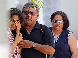 FAMILY ANGUISH: Joseph Garrett Button's father Bert (centre) and sister Cynthia (right) comfort an unknown woman.