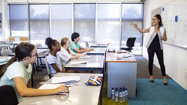 Steph Ronci tutors incoming Year 7 students in a summer school catch-up program at Kolbe Catholic College in Melbourne’s north. Picture: Aaron Francis