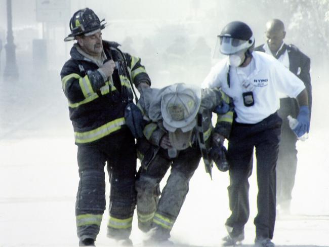 COPY PIC OF Louie Cacchili (L) saving a fire chief as they leave the Twin Towers after the collapse. Louie Cacchioli New York firefighter and face of September 11 (l) with police officer (r) helping fellow rescue worker as they leave the Twin Towers afte the collapse.