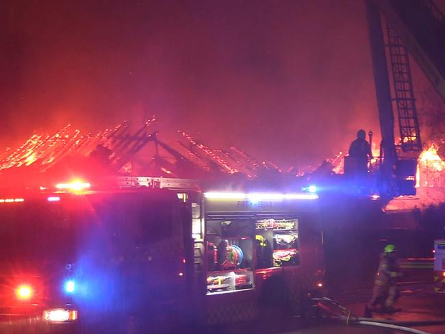 The skeleton of the mansion’s roof is exposed after flames ripped through the house. Picture: OnScene