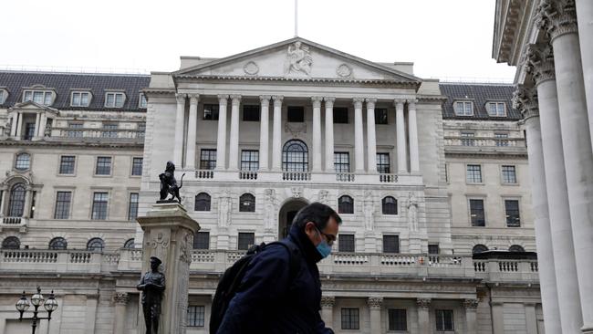 A man wearing protective face mask walks past the Bank of England in the City of London. Picture: AFP