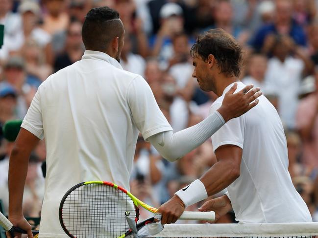 Spain's Rafael Nadal (L) and Australia's Nick Kyrgios (R) shake hands at the net after Nadal won their men's singles second round match on the fourth day of the 2019 Wimbledon Championships at The All England Lawn Tennis Club in Wimbledon, southwest London, on July 4, 2019. (Photo by Adrian DENNIS / AFP) / RESTRICTED TO EDITORIAL USE