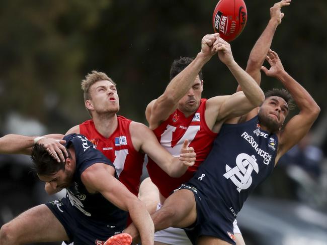 Jackson McMahon and Rigby Barnes of South clash with Callum Wilke and Corey Grove of North.