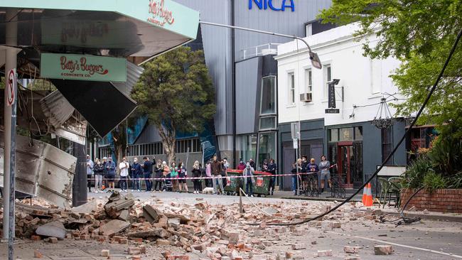 Debris litters Chapel Street, Windsor, after the quake partially demolished a burger shop. Picture: Mark Stewart