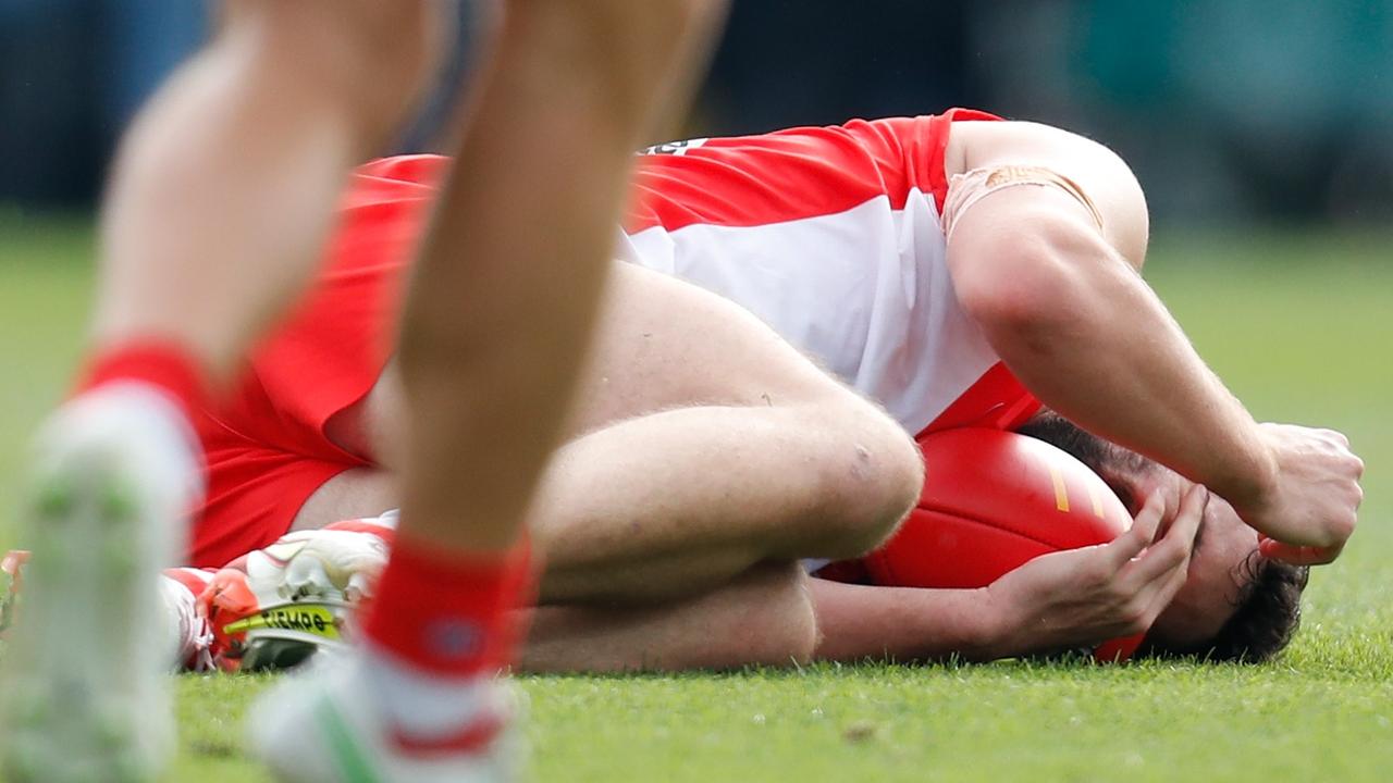 Paddy McCartin holds his head after a collision against Hawthorn. Picture: AFL Photos/Getty Images