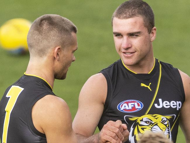 Jack Ross (centre) and Dan Butler of the Tigers are seen during a Richmond Tigers training session at Punt Road Oval in Melbourne, Thursday, April 11, 2019. (AAP Image/Daniel Pockett) NO ARCHIVING