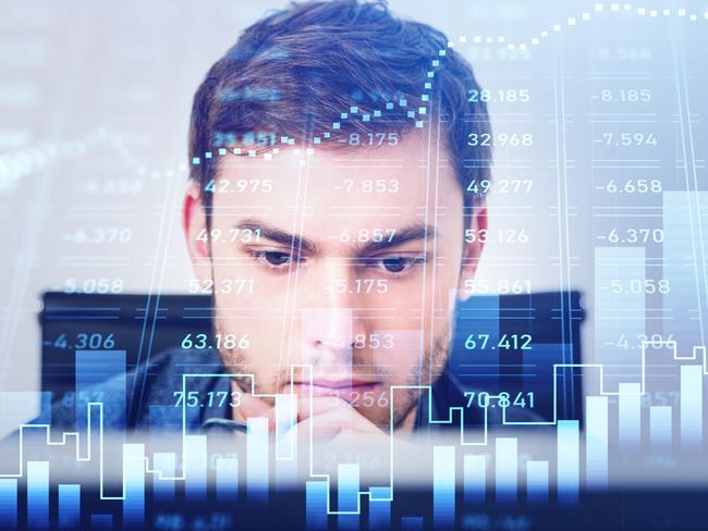 Portrait of trader businessman who is carrying out a research on desktop computer. Forex graph background with overlay. Concept of trading and analytics; stock market investing generic investment