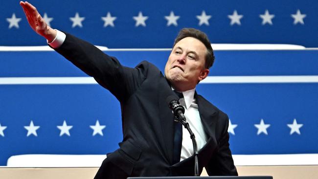 (FILES) Tesla and SpaceX CEO Elon Musk gestures as he speaks during the inaugural parade inside Capitol One Arena, in Washington, DC, on January 20, 2025. Musk's hand gestures at an inauguration event for US President Donald Trump, which quickly drew comparisons to Nazi salutes, appear to have resonated in some far-right extremist spaces online. Several neo-Nazi leaders have shared clips of the viral moment from Musk's Monday speech, in which the billionaire brought his hand to his chest and extended it straight out, twice, before saying: "My heart goes out to you." (Photo by ANGELA WEISS / AFP)