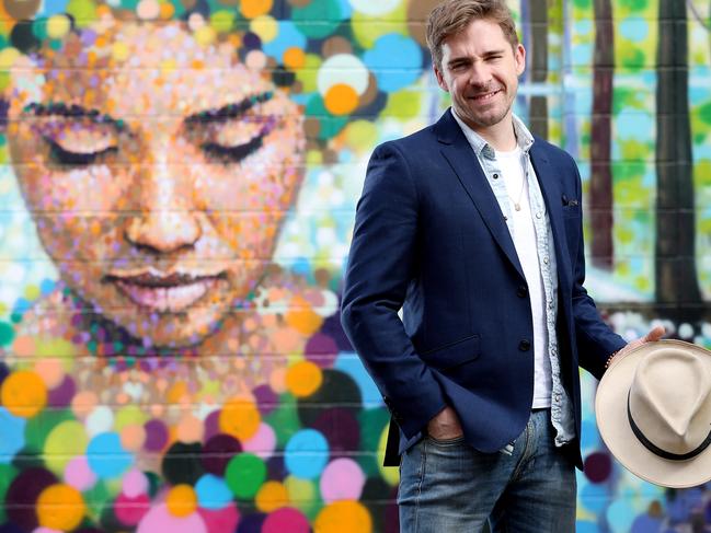 27/09/16 Next year's Fringe Festival ambassador Hugh Sheridan with a mural by artist Jimmy C (James Cochran) in Kent Town. photo Calum Robertson