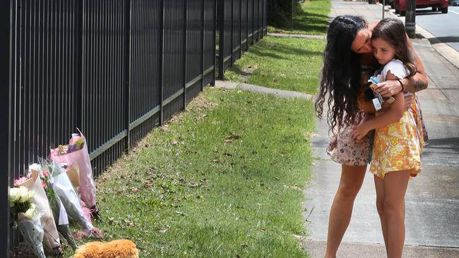 Classmate London McGrath and mother Kelly Scoble drop off a floral tribute at a Tweed school for a murdered schoolgirl. Picture: Glenn Hampson