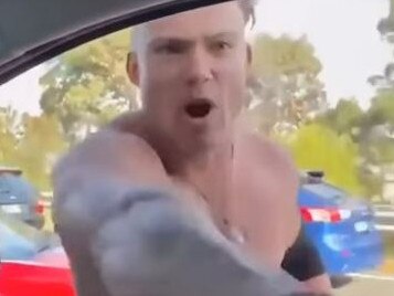 Bizarre footage has emerged of a shirtless man smashing a car window and yelling about vaccines. Picture: 9NEWS
