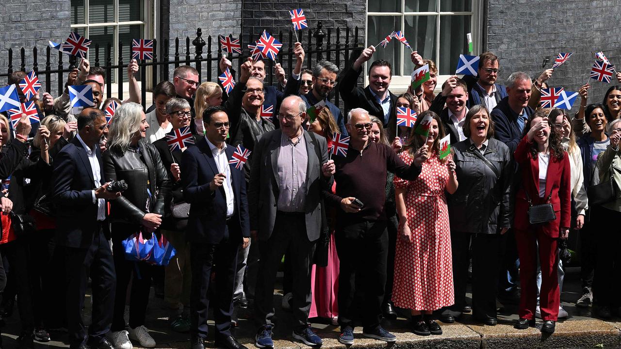 Labour Party supporters wait outside 10 Downing Street in London for Sir Keir Starmer. Picture: AFP