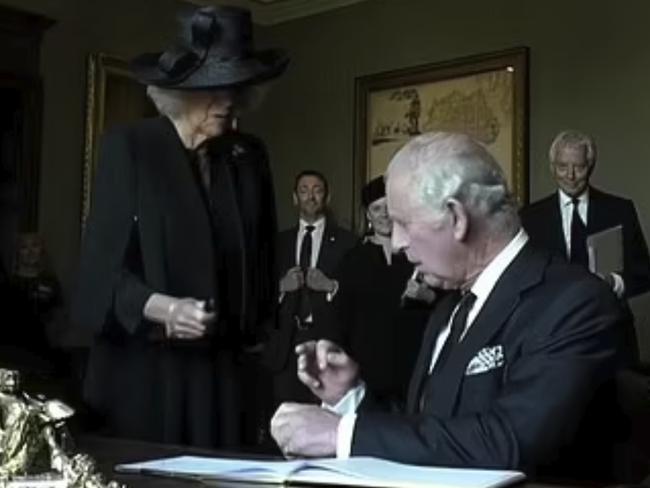 Leaky pen episode … King Charles gets frustrated while signing the guest book at Hillsborough Castle, Northern Ireland.