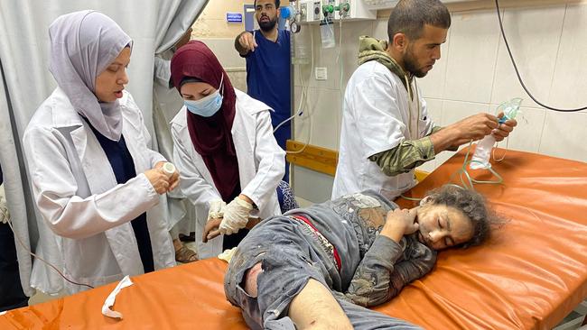 Palestinian doctors care for a girl who was injured in Israeli strikes, at the Nasser hospital in Khan Yunis. Picture: AFP