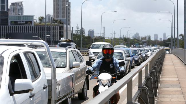 A motorcyclist tries to get past the heavy traffic along the Sundale Bridge heading to The Spit. Photo: Regi Varghese