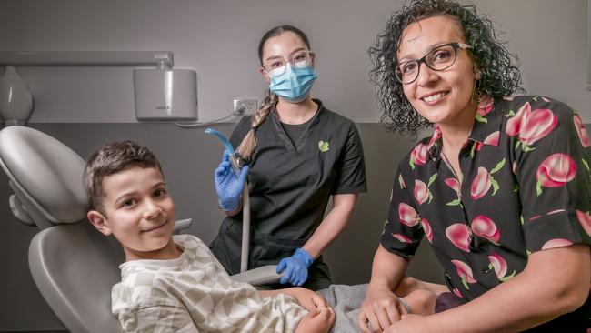 Ryan Shukri-Gilmore, 7, and mum Denise Shukri with dental assistant April Mansbridge at St Lukes Dental Clinic at Shoreline Plaza. Picture: Caroline Tan