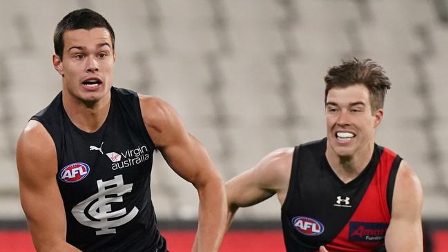 Zach Merrett chases Jack Silvagni in the opening term before catching him with a jab to the ribs.