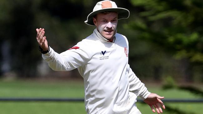 Isaac Willett celebrates a catch for Essendon.