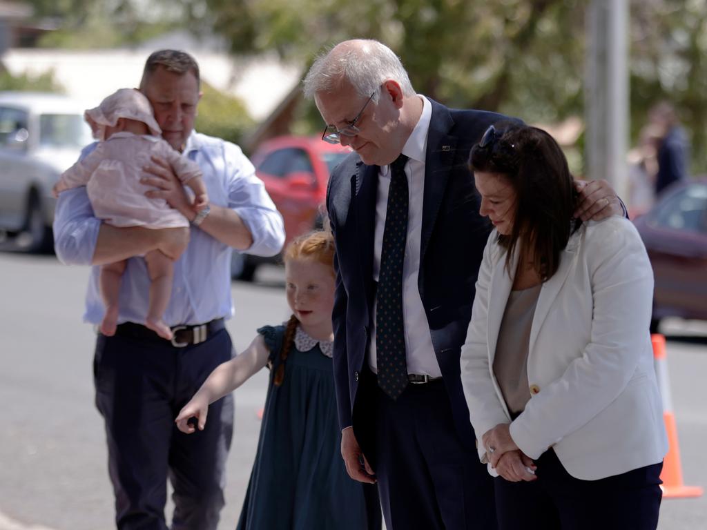 Prime Minister Scott Morrison, his wife Jenny and Braddon MP Gavin Pearce and his family lay flowers outside Hillcrest Primary School. Picture: NCA NewsWire / Grant Viney