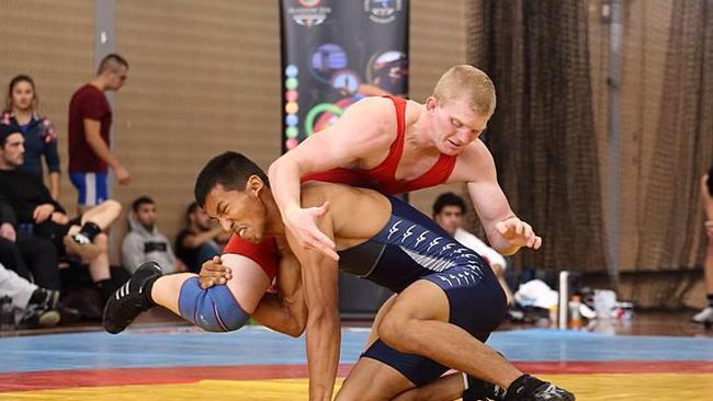 Jayden Lawrence (top), of Catherine Field, wins at the Australian wrestling championships, also Commonwealth Games qualifiers.