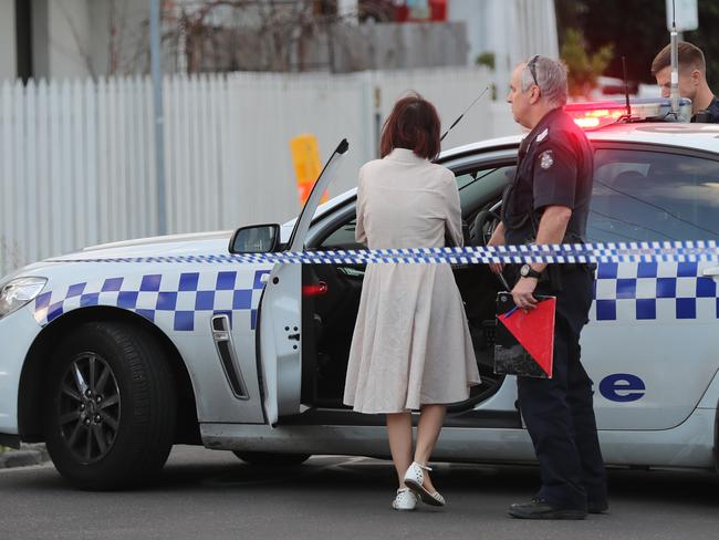 Police and an unknown woman at the scene of a Richmond shooting. Picture: Alex Coppel