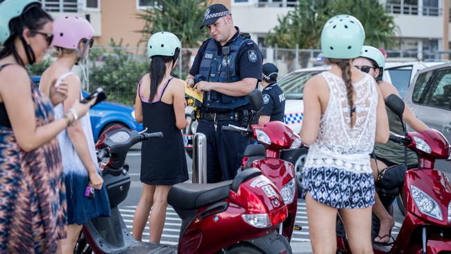 Schoolies riding hire scooters are fined for beeping their horns. Picture: Jake Nowakowski