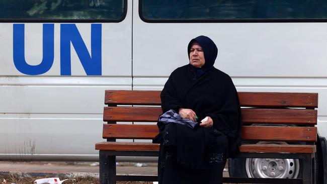 A displaced Palestinian woman sits on a bench as she waits outside a UNRWA clinic in Rafah in the southern Gaza Strip on Sunday. Picture: AFP