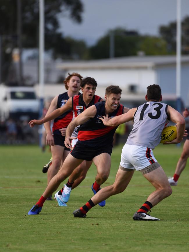 Bairnsdale coach, Logan Austin, attempts to tackle Maffra forward John Butcher. Picture: Bairnsdale Advertiser