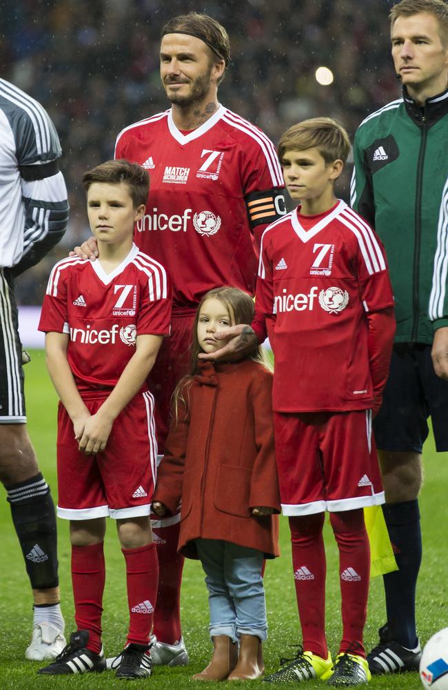 David Beckham stands with his children before the Unicef Match for Children charity football match between a Great Britain and Ireland team and a Rest of the World team at Old Trafford Stadium, Manchester. Picture: AP