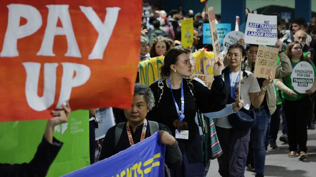 Activists gather with banners, including one that reads “Pay Up”, outside the plenary halls of the COP29 Climate Conference to voice their demands for a variety of climate-related issues, including labour rights, indigenous peoples' rights, loss and damage financing, and the expulsion of fossil fuel lobbyists from the conference. Picture: Sean Gallup/Getty Images