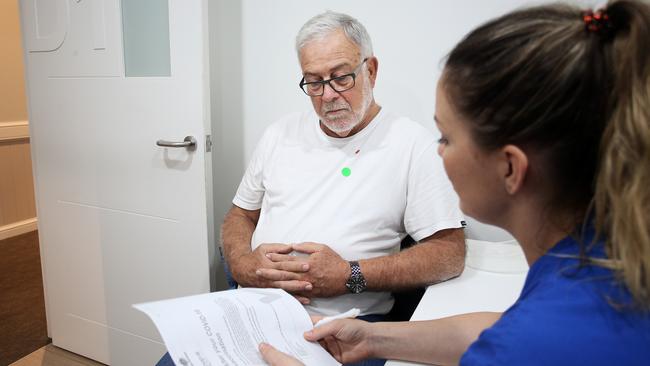 Robert Yeates speaks with nurse Emma McCallum ahead of getting his COVID-19 AstraZeneca vaccine from at the Sydney Road Family Medical Practice. Picture: Lisa Maree Williams/Getty Images