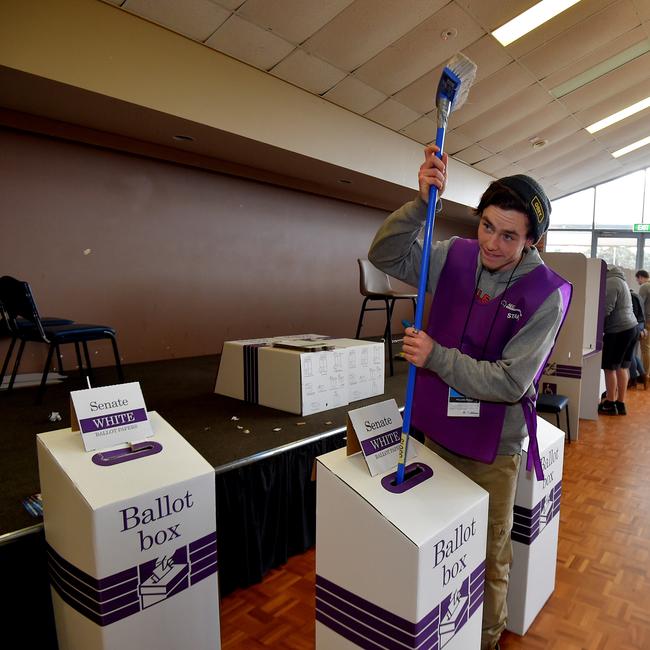 A Polling Booth staffer crams the Senate Ballot Papers into the box at the polling booth at Strathfieldsaye Sports Centre. Picture: Jay Town