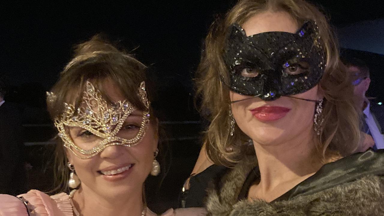 Erin Dore and Bree White celebrate at the Gympie RSL Masked Ball, April 29 2023.